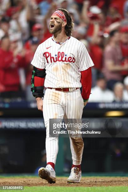 Bryce Harper of the Philadelphia Phillies celebrates after scoring a run during the eighth inning against the Miami Marlins in Game One of the Wild...