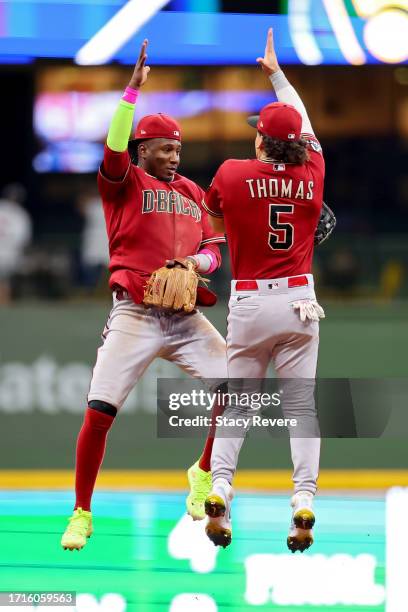 Geraldo Perdomo and Alek Thomas of the Arizona Diamondbacks celebrate after beating the Milwaukee Brewers 6-3 in Game One of the Wild Card Series at...