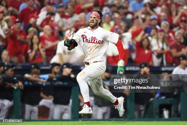 Bryce Harper of the Philadelphia Phillies runs on his way to scoring a run during the eighth inning against the Miami Marlins in Game One of the Wild...