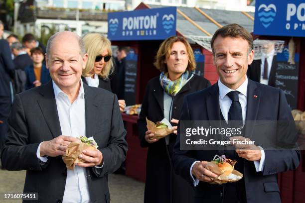 German Chancellor Olaf Scholz, his wife Britta Ernst, French President Emmanuel Macron and his wife Brigitte Macron eat fish sandwiches on the second...