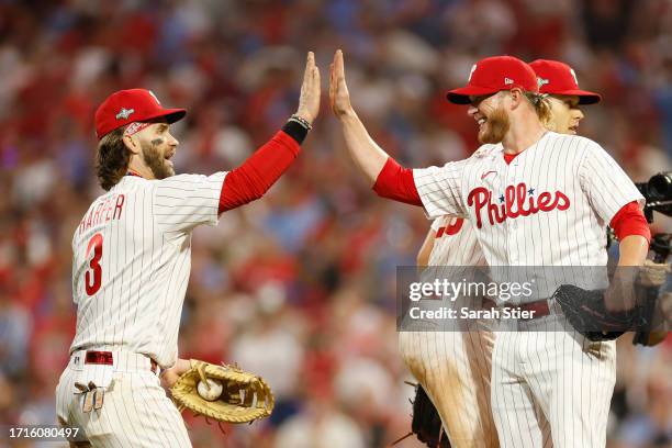 Bryce Harper of the Philadelphia Phillies celebrates with Craig Kimbrel after defeating the Miami Marlins 4-1 in Game One of the Wild Card Series at...