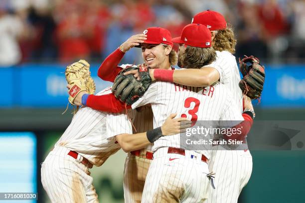 Bryce Harper of the Philadelphia Phillies celebrates with teammates after defeating the Miami Marlins 4-1 in Game One of the Wild Card Series at...