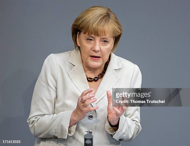 German Chancellor Angela Merkel gives a government declaration on the annual G8 leaders summit on European Council meeting at the Reichstag, the seat...