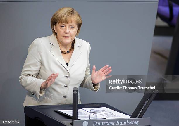 German Chancellor Angela Merkel gives a government declaration on the annual G8 leaders summit on European Council meeting at the Reichstag, the seat...