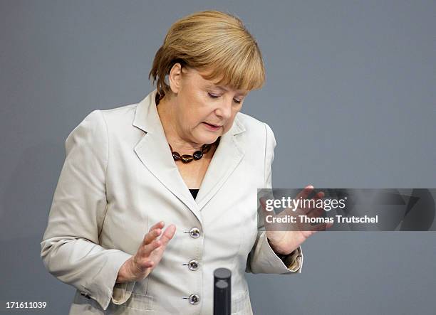 German Chancellor Angela Merkel gives a government declaration on the annual G8 leaders summit on European Council meeting at the Reichstag, the seat...