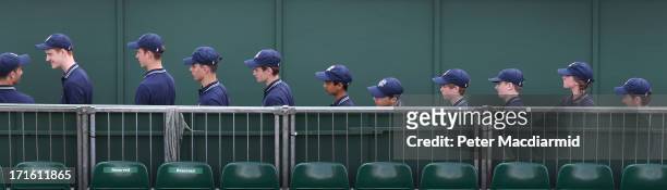 Ball boys and ball girls line up to enter a court on day four of the Wimbledon Lawn Tennis Championships at the All England Lawn Tennis and Croquet...