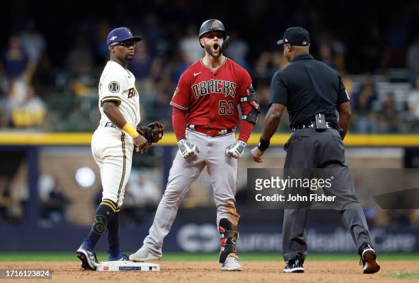 Christian Walker of the Arizona Diamondbacks celebrates after hitting a two-run RBI double during the ninth inning against the Milwaukee Brewers...