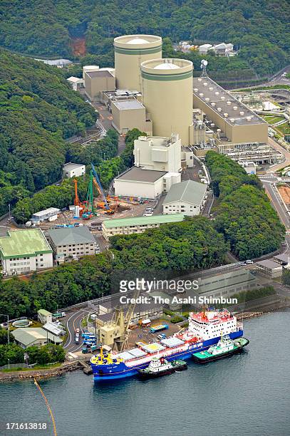 In this aerial image, a container of mixed oxide fuel is unloaded from a freighter at Kansai Electric Power Co Takahama Nuclear Power Plant on June...