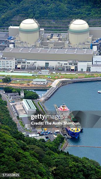 In this aerial image, a container of mixed oxide fuel is unloaded from a freighter at Kansai Electric Power Co Takahama Nuclear Power Plant on June...