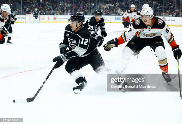 Trevor Moore of the Los Angeles Kings skates the puck against Tristan Luneau of the Anaheim Ducks in the second period of a preseason game at...