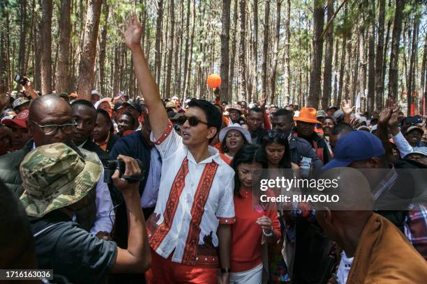 Incumbent Madagascar President Andry Rajoelina, greets supporters as he attends the first meeting of his electoral campaign, in Antananarivo, on...