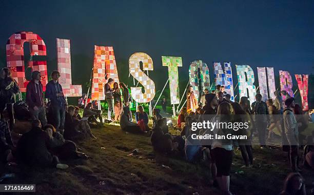 Festival-goers enjoy the atmosphere prior to the 2013 Glastonbury Festival at Worthy Farm on June 26, 2013 in Glastonbury, England.