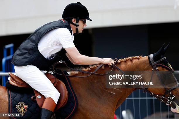 French Guillaume Canet competes in the 2013 Monaco International Jumping as part of Global Champions Tour on June 27, 2013 in Monte-Carlo. AFP PHOTO...