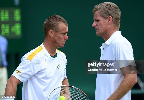 Lleyton Hewitt of Australia and Mark Knowles of the Bahamas talk during the Gentlemen's Doubles first round match between Jamie Delgado of Great...