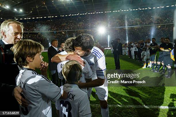 Michael Ballack hugs his three sons after the Michael Ballack farewell match 'Ciao Capitano' at the Red Bull Arena on June 5, 2013 in Leipzig,...