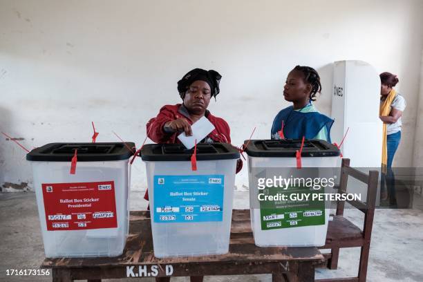 Women casts her ballot at a voting station in Kenny Town, Monrovia on October 10, 2023 during the presidential vote. Liberians began voting Tuesday...