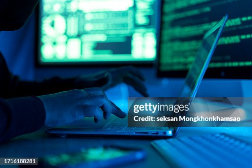 Hacker using laptop. Lots of digits on the computer screen. Hacker using laptop. Lots of digits on the computer screen.