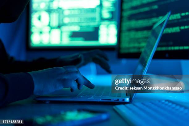 hacker using laptop. lots of digits on the computer screen. - computer crime stock pictures, royalty-free photos & images