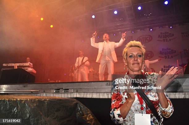 Fan in front of the stage is dancing as Nockalm Quintett perform on stage during the 30th anniversary of Donauinselfest 2013 on June 23, 2013 in...