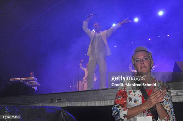 Fan in front of the stage is dancing as Nockalm Quintett perform on stage during the 30th anniversary of Donauinselfest 2013 on June 23, 2013 in...