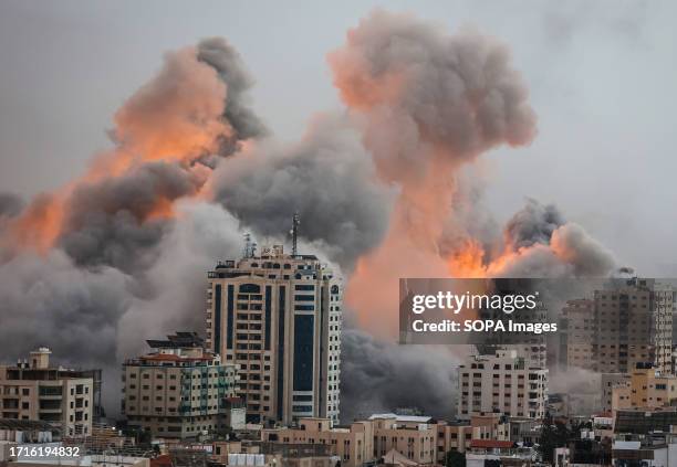 Flames and smoke billow during Israeli strikes in Gaza. Israel imposed a total siege on the Gaza Strip on October 9 and cut off the water supply as...