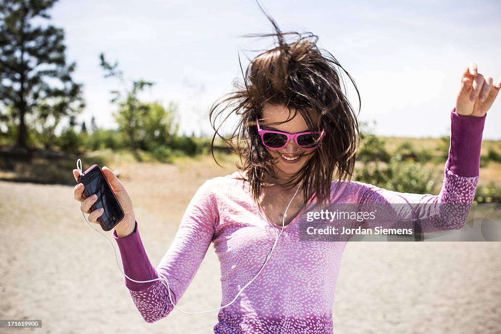 A woman dancing to her iPod.