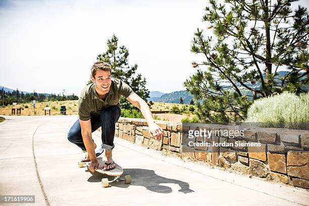a man skateboarding. - longboard skating stock pictures, royalty-free photos & images