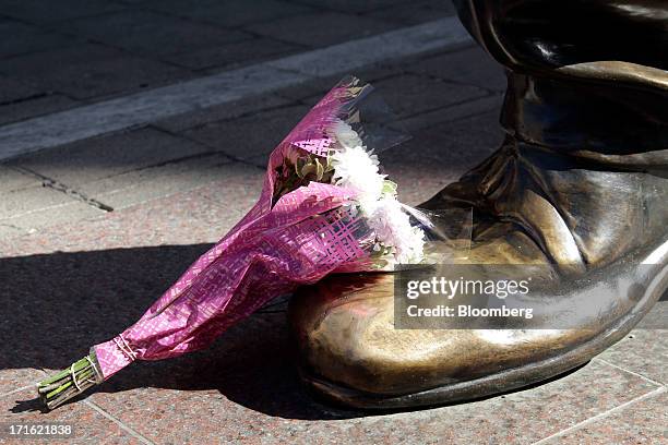 Floral tribute is placed on the foot of a giant statue to former South African president Nelson Mandela at Nelson Mandela square in Johannesburg,...