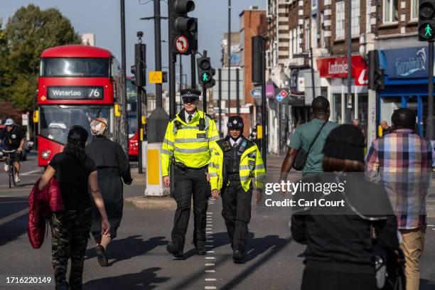 Police officers patrol through Stamford Hill, an area of London with a large Jewish community, on October 10, 2023 in London, England. Fearing a rise...