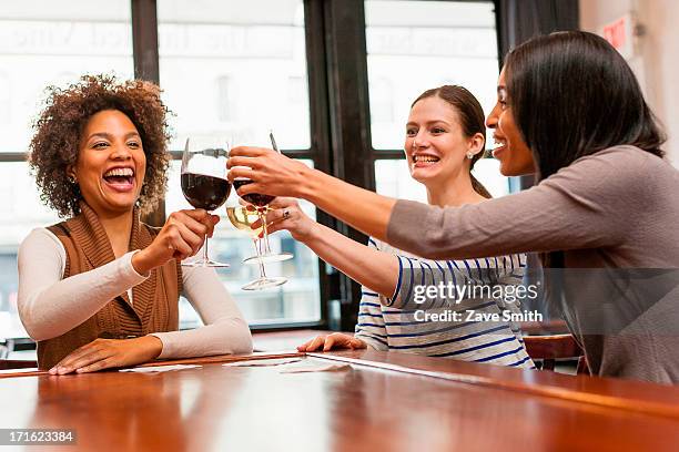 friends toasting at wine bar - winebar stock pictures, royalty-free photos & images