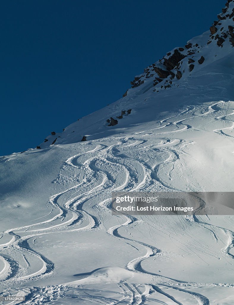 Ski tracks in snow on mountain