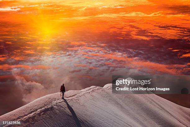 person on mountain at sunset, piz palu, st moritz, canton graubunden, switzerland - saint moritz stock-fotos und bilder