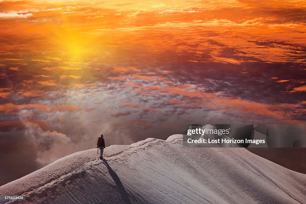 Person on mountain at sunset, Piz Palu, St Moritz, Canton Graubunden, Switzerland