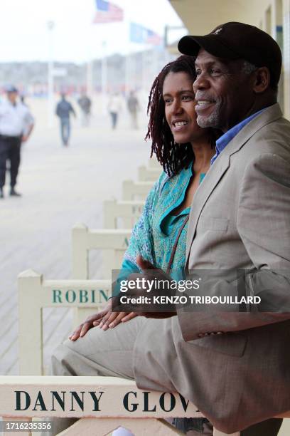Actor Danny Glover and his wife Asake Bomani pose next to the beach closet dedicated to him on the Promenade des Planches in the French northwestern...
