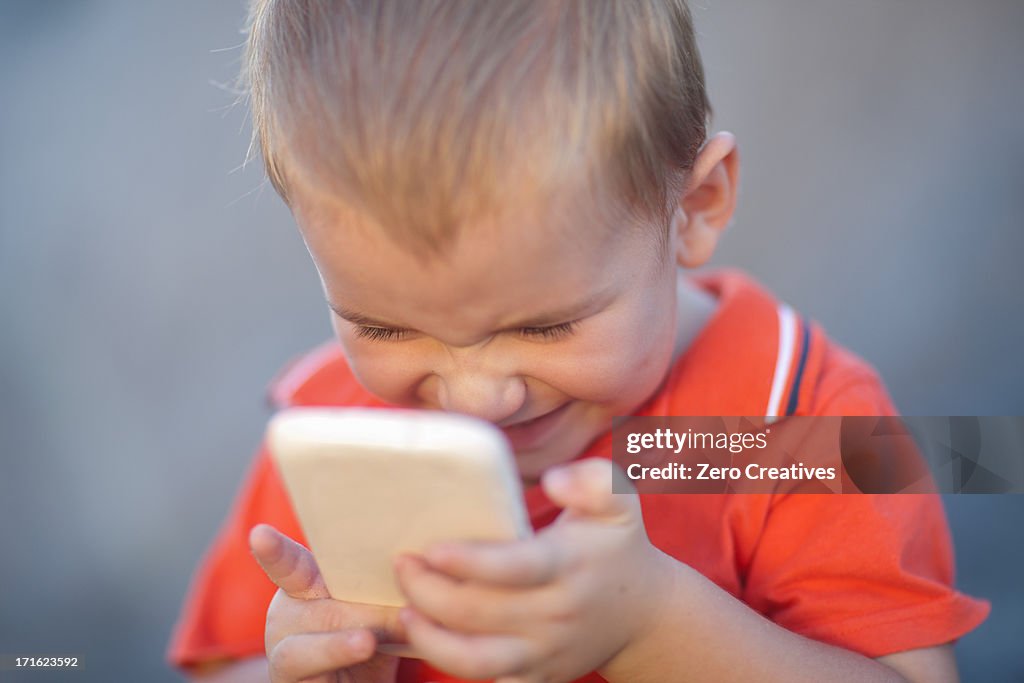 Boy playing on smartphone