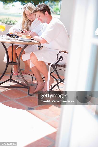 Young Couple Having Breakfast On Patio, Foto de stock