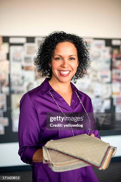 mature woman holding textile swatch - purple blouse stock pictures, royalty-free photos & images