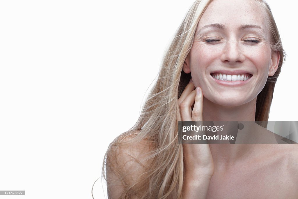 Young woman touching neck