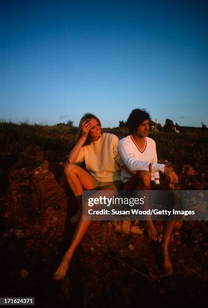 Portrait of American model and actress Cheryl Tiegs and her husband, film director Stan Dragoti, both barefoot ans dressed in shorts and sweaters, as...