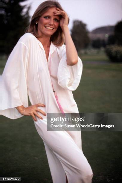 Portrait of American model and actress Cheryl Tiegs as she poses outdoors, dressed in a pink robe, at La Costa Resort & Spa, Carlsbad, California,...