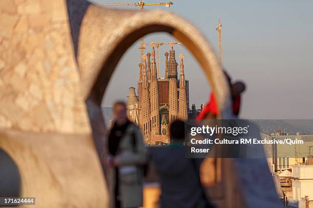 view from casa mila towards sagrada familia, barcelona, spain - familia casa stock pictures, royalty-free photos & images