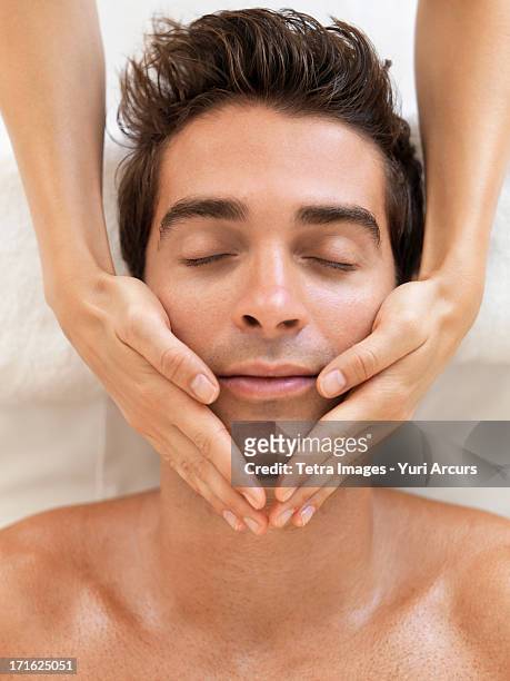 south africa, cape town, man receiving massage in spa - human body part stock-fotos und bilder