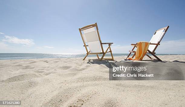 usa, massachusetts, nantucket island, sun chairs on sandy beach - sandsun stock-fotos und bilder