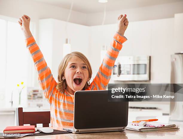 usa, utah, lehi, excited girl (6-7) with laptop - one girl stock-fotos und bilder