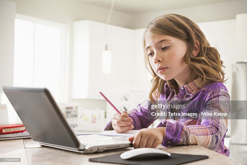 USA, Utah, Lehi, Girl (6-7) using laptop