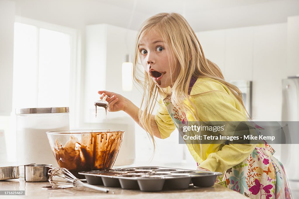 USA, Utah, Lehi, Girl (6-7) baking cupcakes