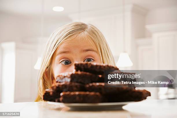 usa, utah, lehi, girl (6-7) looking at heap of brownies - kid looking up stock pictures, royalty-free photos & images