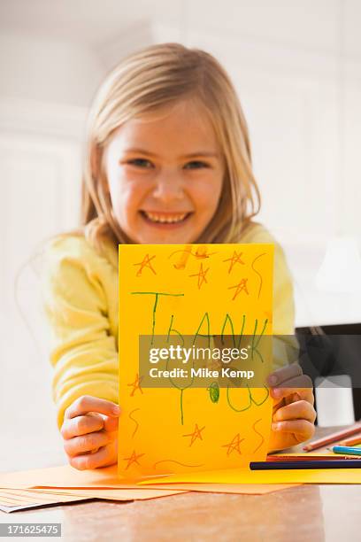 usa, utah, lehi, girl (6-7) holding drawing with text 'thank you' - lehi stock pictures, royalty-free photos & images