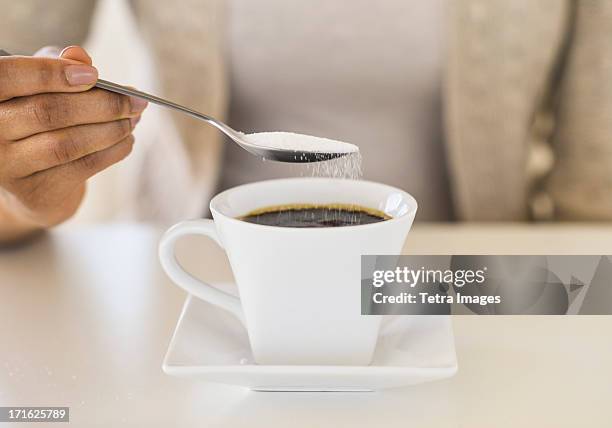 usa, new jersey, jersey city, close-up of woman sweetening coffee - coffee spoon stock pictures, royalty-free photos & images