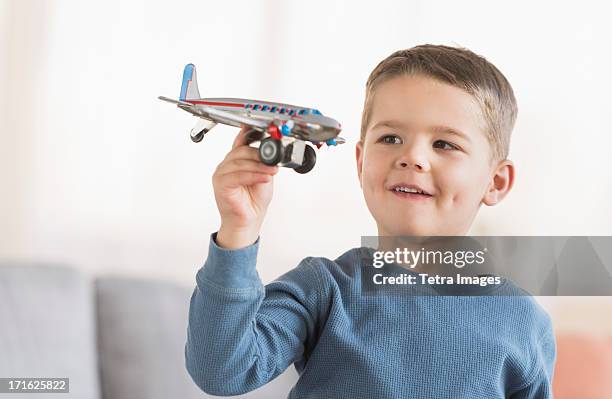 usa, new jersey, jersey city, boy (4-5) playing with toy plane - model airplane stock pictures, royalty-free photos & images